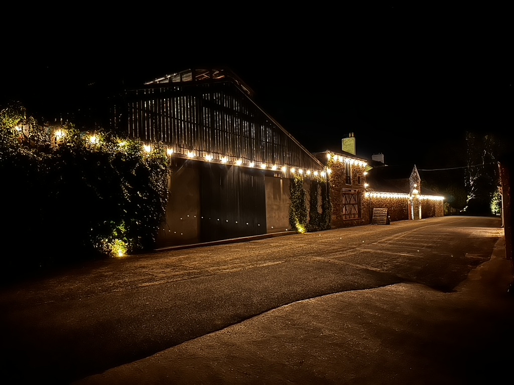 ANRÁN barns illuminated with festoon lighting at night