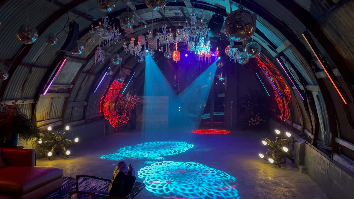 Colourful DIS2GO lighting across the dance floor inside the Nissen Hut