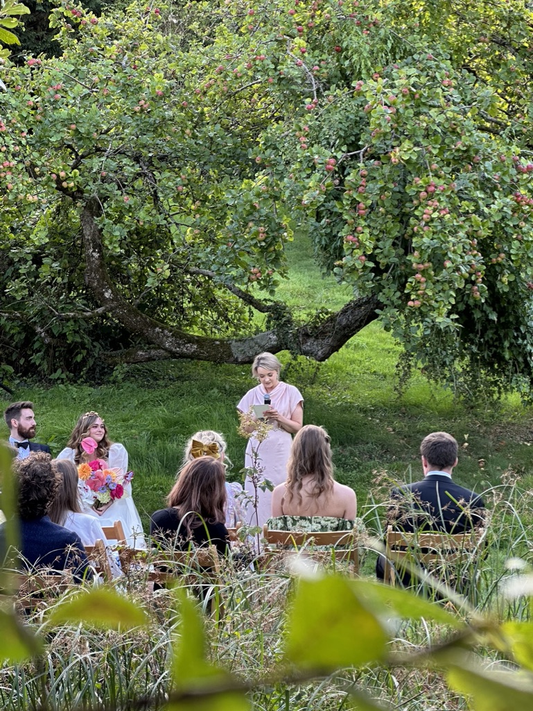 An intimate wedding ceremony beneath the apple trees
