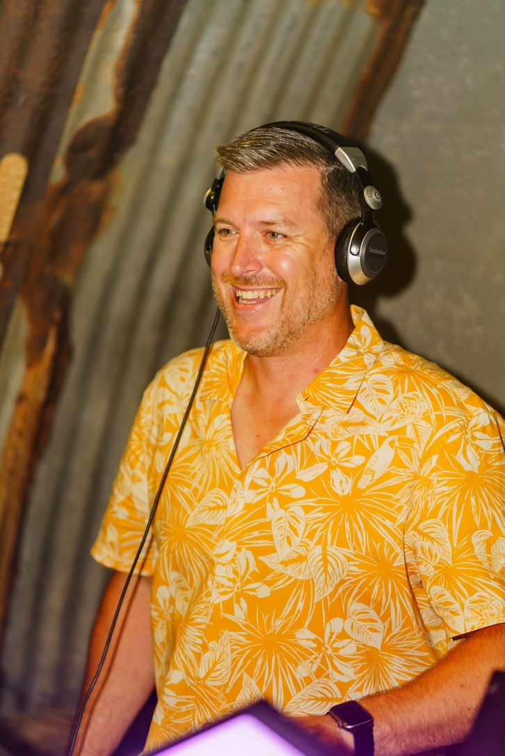 Shaun from DIS2GO wearing headphones while DJing